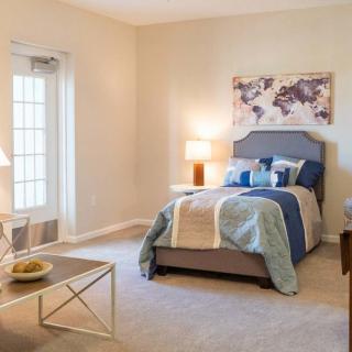 A cozy and well-decorated bedroom with natural light.
