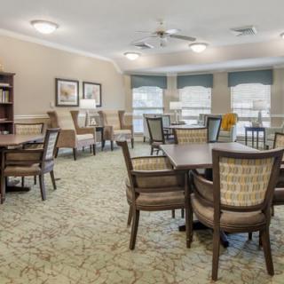 A cozy interior space with multiple tables and chairs, tastefully decorated.