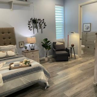 A serene and stylish bedroom featuring modern decor and cozy furnishings.