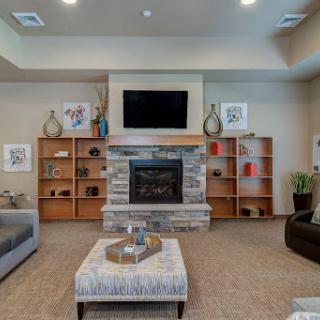 A cozy and modern living room featuring a stone fireplace and stylish furniture.