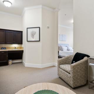 A cozy living space with a kitchenette and comfortable seating.