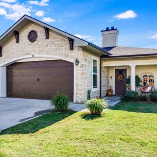 A modern suburban house with a well-maintained lawn and a two-car garage.