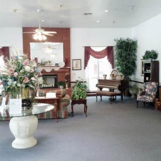 A well-decorated living room with a fireplace and various furnishings.