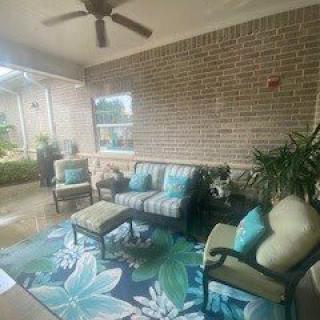 A cozy outdoor patio with comfortable seating and vibrant decor.