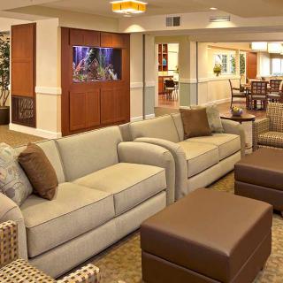 A modern and cozy seating area with sofas and ottomans in a stylishly decorated living space.