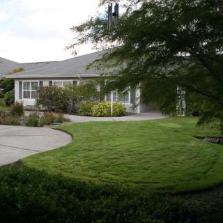 A suburban house with a well-maintained lawn and garden.