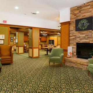 A cozy hotel lobby with comfortable seating and a fireplace.