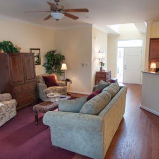 A cozy living room featuring comfortable seating, warm lighting, and inviting decor.