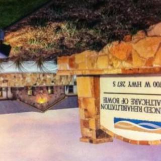 A stone sign at the entrance of a building.