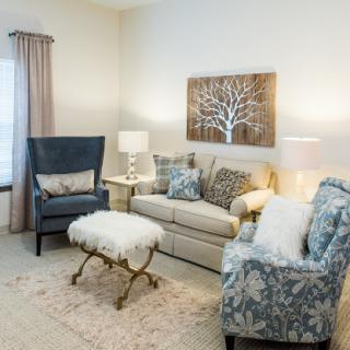 A cozy and elegantly designed living room featuring a comfortable sofa and stylish armchairs.
