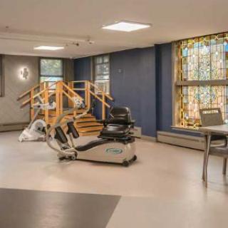 An indoor rehabilitation and therapy room featuring exercise equipment.