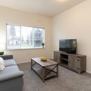 A modern living room with a sofa, coffee table, and television.