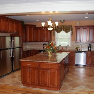 A spacious kitchen with wooden cabinets, a central island, and stainless steel appliances.