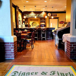 A welcoming view of the interior of Digger & Finch, featuring a cozy dining area and bar.