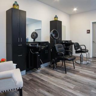 A modern hair salon with styling chairs and mirrors.