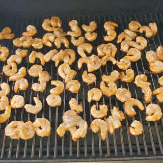 Shrimp being grilled on a barbecue.