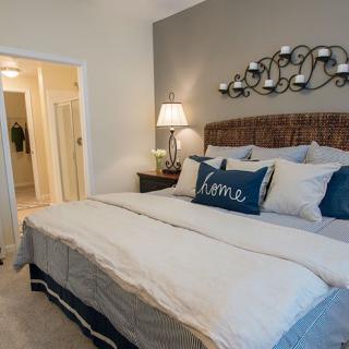 Cozy bedroom with a stylish bed and elegant lighting.
