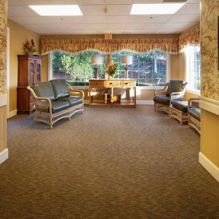 A cozy waiting room with comfortable seating and large windows.
