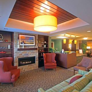 A cozy living room interior with comfortable seating and warm lighting.