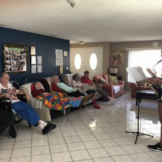 A group of people relaxing on couches in a living room setting.