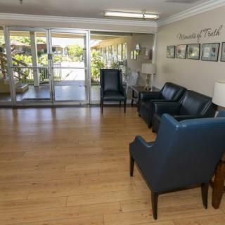 A lobby area with comfortable seating and a wooden floor.