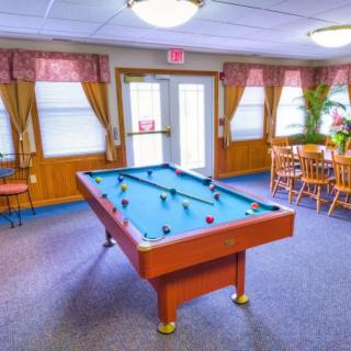 A cozy game room featuring a pool table and seating area.