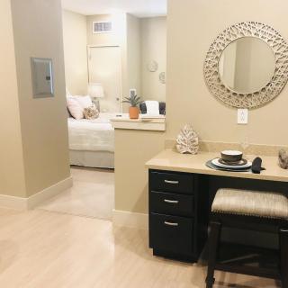Cozy apartment interior featuring a small desk and adjacent bedroom.