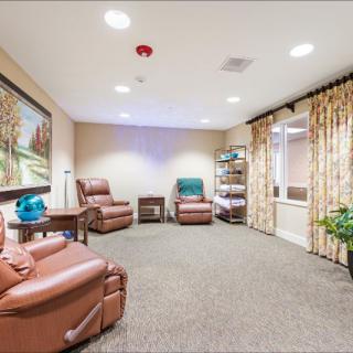 A spacious waiting room with comfortable seating and decor.