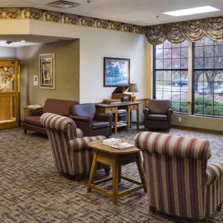 A cozy lobby area featuring comfortable seating and decorative elements.