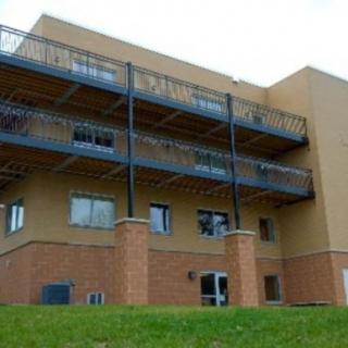 A modern building with multiple balconies and brick faade.