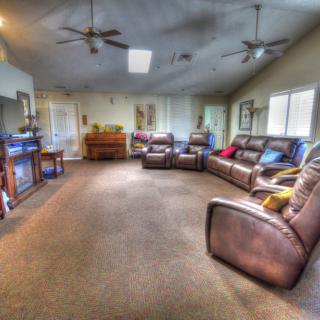 Spacious living room with comfortable seating and a TV setup.