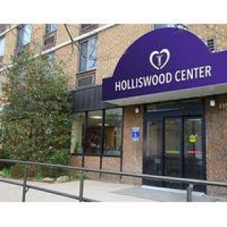 Entrance to the Holliswood Center with a purple sign.