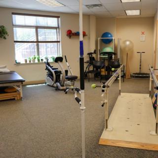 A physical therapy room equipped with exercise and rehabilitation equipment.