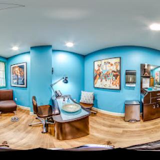 A modern office space featuring vibrant blue walls and artistic decor.
