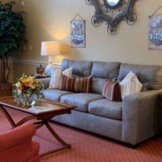 A cozy living room with a comfortable sofa, coffee table, and decorative elements.