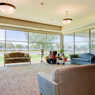 A spacious lobby area with large windows, featuring comfortable seating and ample natural light.