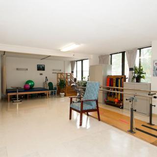 A spacious rehabilitation center featuring various exercise and therapy equipment.