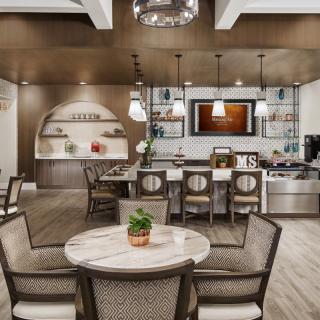 A modern kitchen and dining area with elegant decor and stylish lighting.