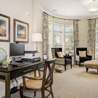 Elegant home office with a cozy seating area and tasteful decor.