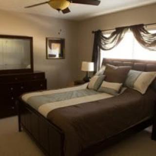 A cozy bedroom with a nicely made bed and elegant decor.