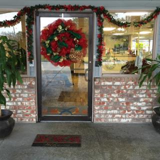 A beautifully decorated door with a festive wreath for the holiday season.