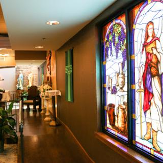 A beautifully decorated hallway featuring vibrant stained glass windows, adding an artistic touch to the interior space.