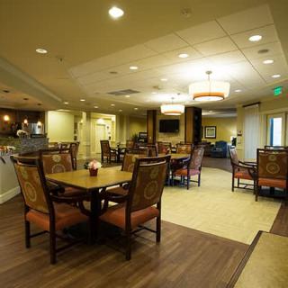 A cozy dining area with elegant lighting and comfortable seating arrangements.