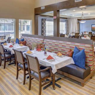 A spacious restaurant dining area with table settings and comfortable seating.