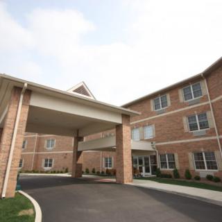An exterior view of a brick building with a covered entrance.