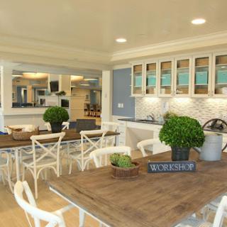 A beautifully designed open-concept kitchen and dining area featuring modern furnishings and greenery.