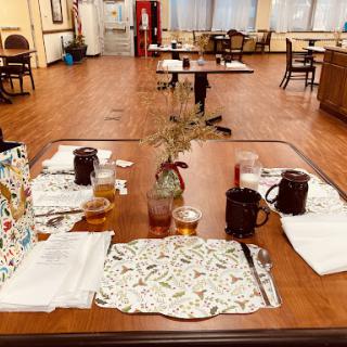 A cozy dining area with neatly arranged tables and decor, ready for a meal.