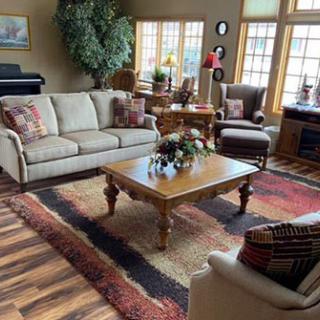 A cozy living room with a sofa, armchairs, and a coffee table.