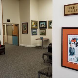 A cozy waiting area featuring several pieces of artwork on the walls.