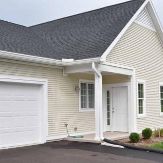 A suburban house with a garage and driveway.